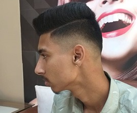 Stylist giving haircut to a male customer
