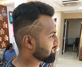 Stylist giving haircut to a male customer